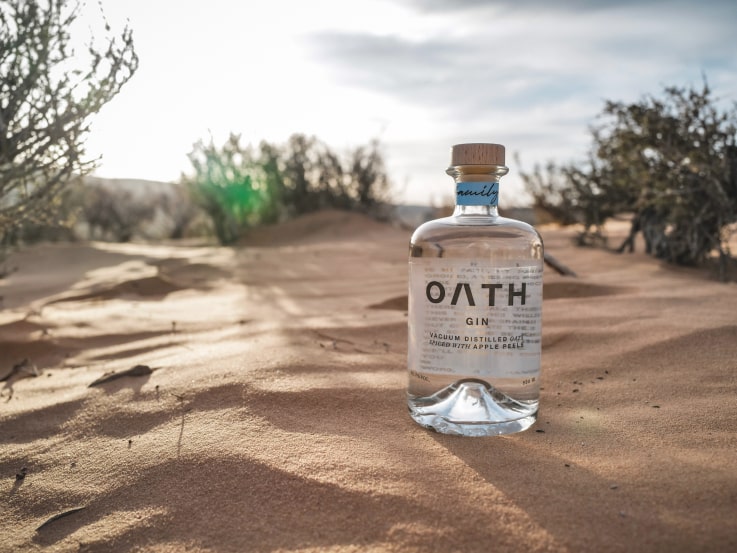 Photo of a bottle of Oath gin in the desert