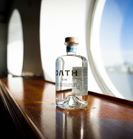 Bottle of Oath gin above a table